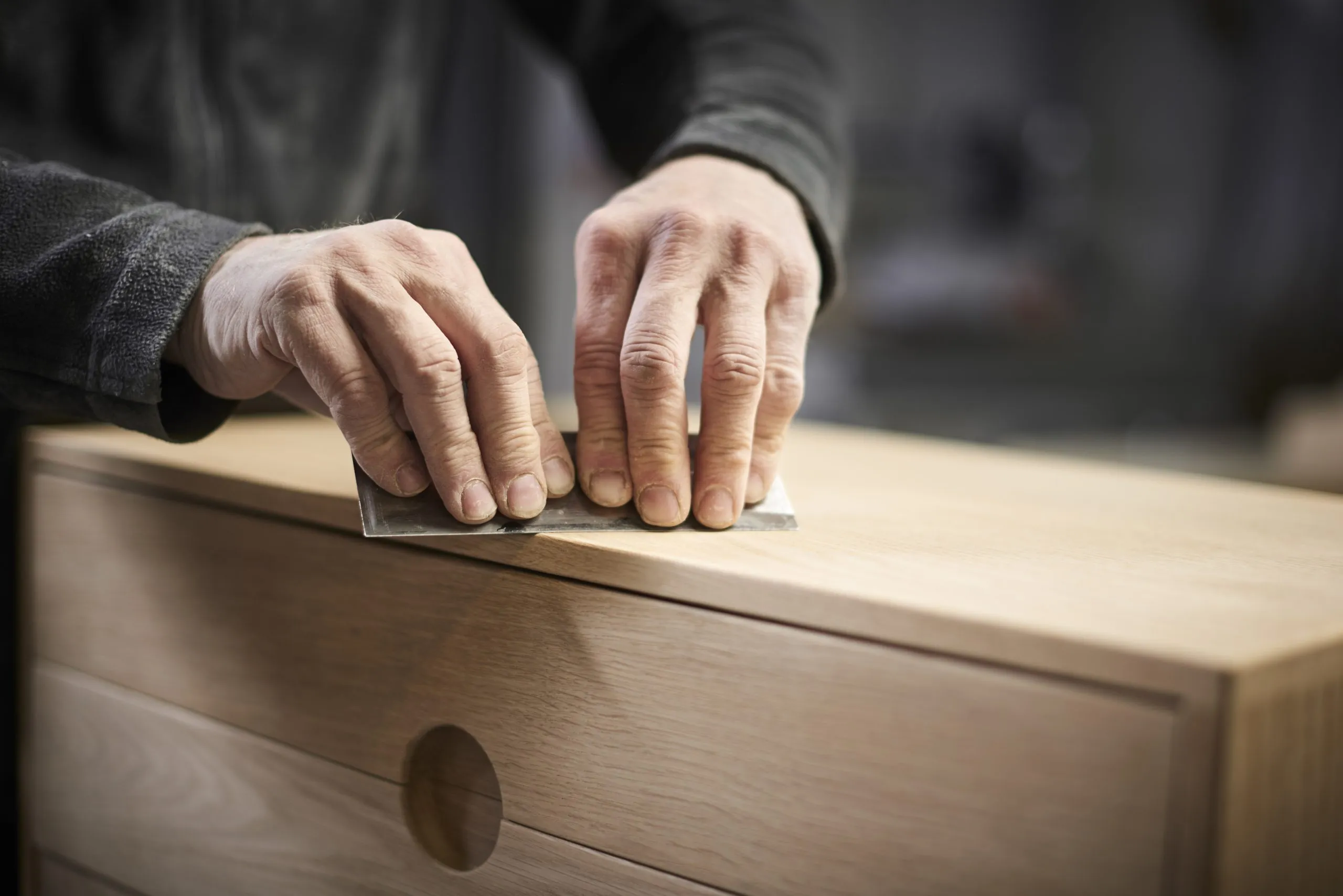 Scraping oak cabinet